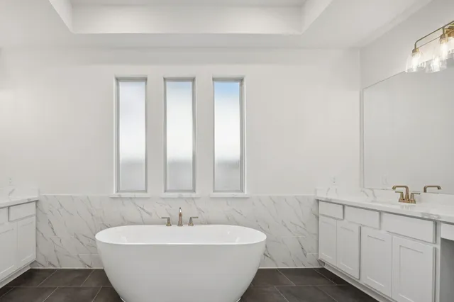 a spacious bathroom with a bathtub and a sink