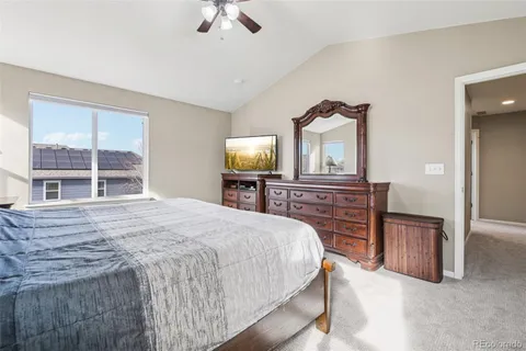 a bedroom with a bed and a dresser with mirror