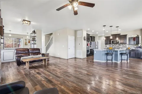 a living room with furniture and kitchen view
