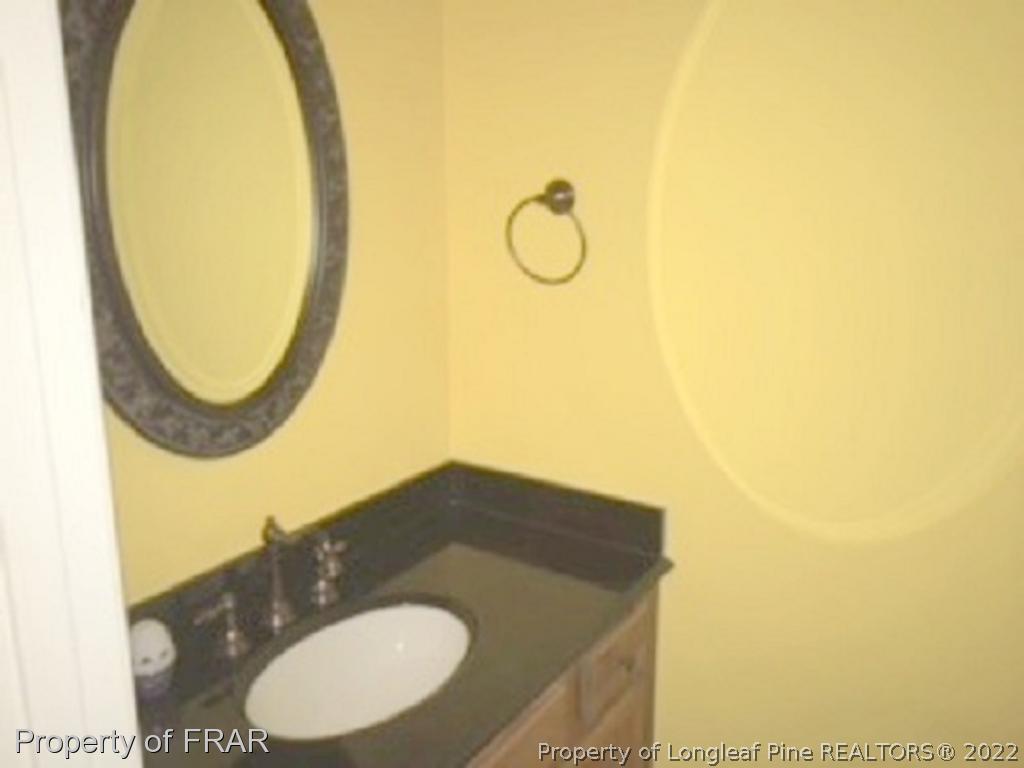 3124 Brechin Road Fayetteville, NC 28303 - Photo 11 of 18 a bathroom with a sink and a mirror