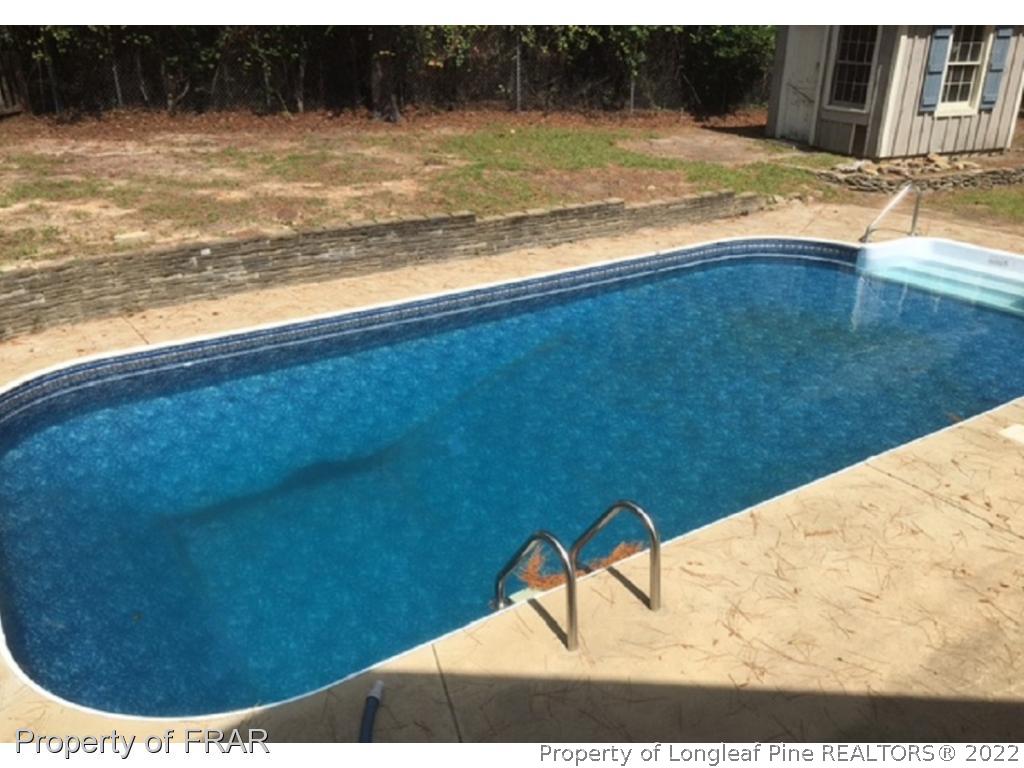 3124 Brechin Road Fayetteville, NC 28303 - Photo 17 of 18 a view of a swimming pool with a yard