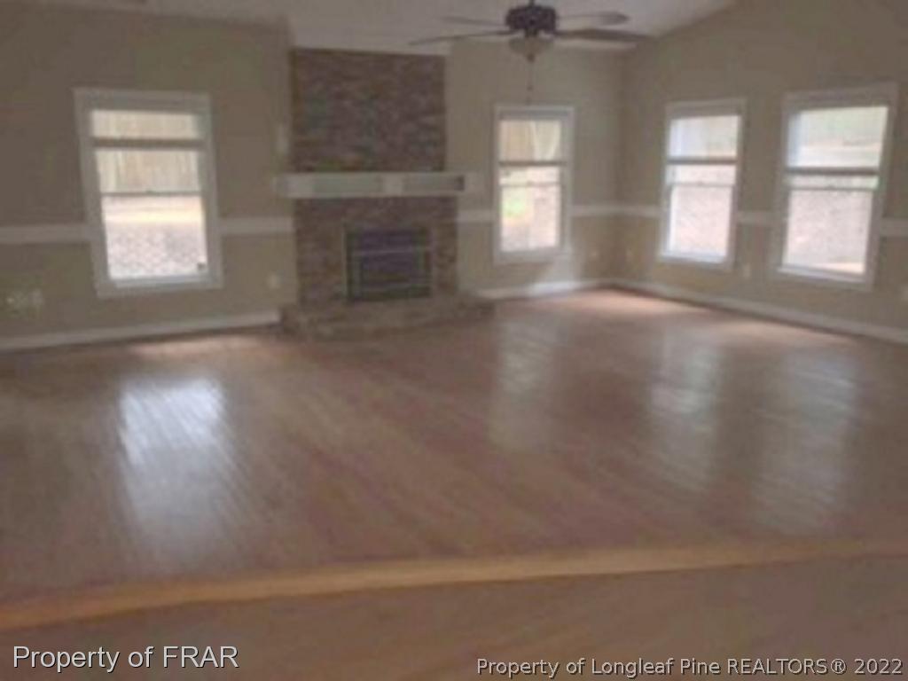 3124 Brechin Road Fayetteville, NC 28303 - Photo 2 of 18 an empty room with windows and fireplace