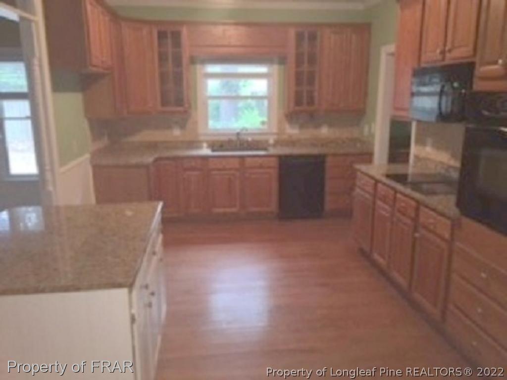 3124 Brechin Road Fayetteville, NC 28303 - Photo 4 of 18 a kitchen with stainless steel appliances a sink a stove a microwave a sink and a refrigerator