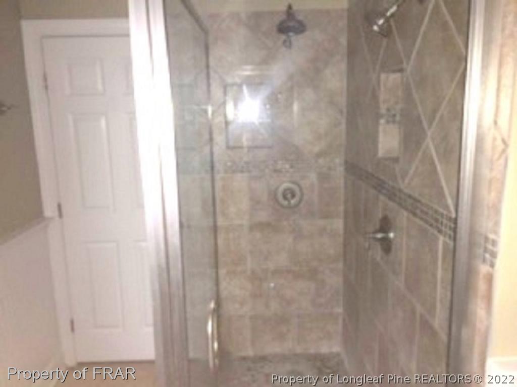 3124 Brechin Road Fayetteville, NC 28303 - Photo 8 of 18 a bathroom with a glass shower door