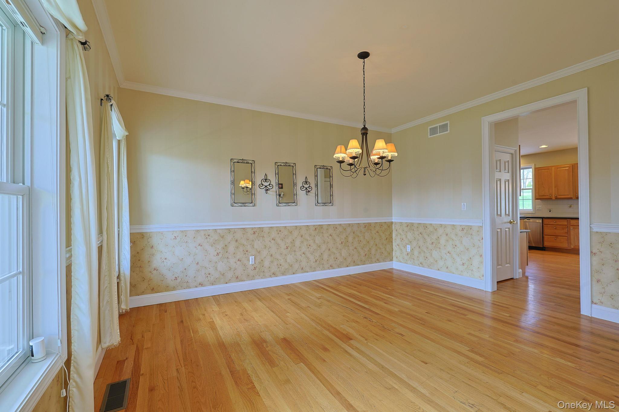 99 Country Club Road Hopewell Junction, NY 12533 - Photo 11 of 44 a view of a room with wooden floor chandelier and a kitchen