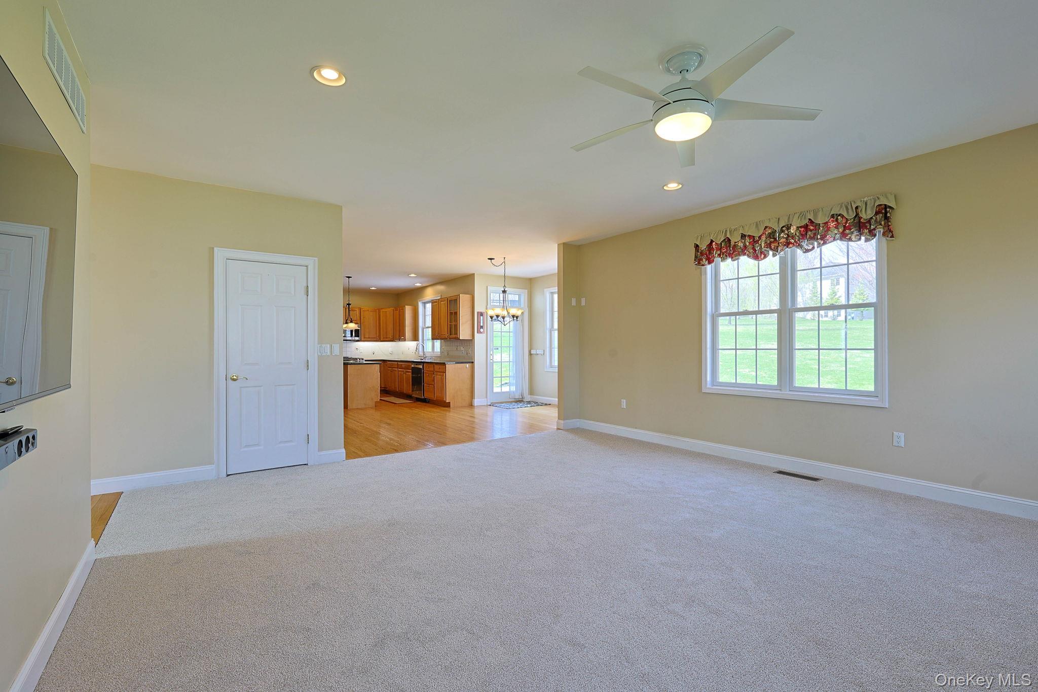 99 Country Club Road Hopewell Junction, NY 12533 - Photo 14 of 44 an empty room with a window and a kitchen