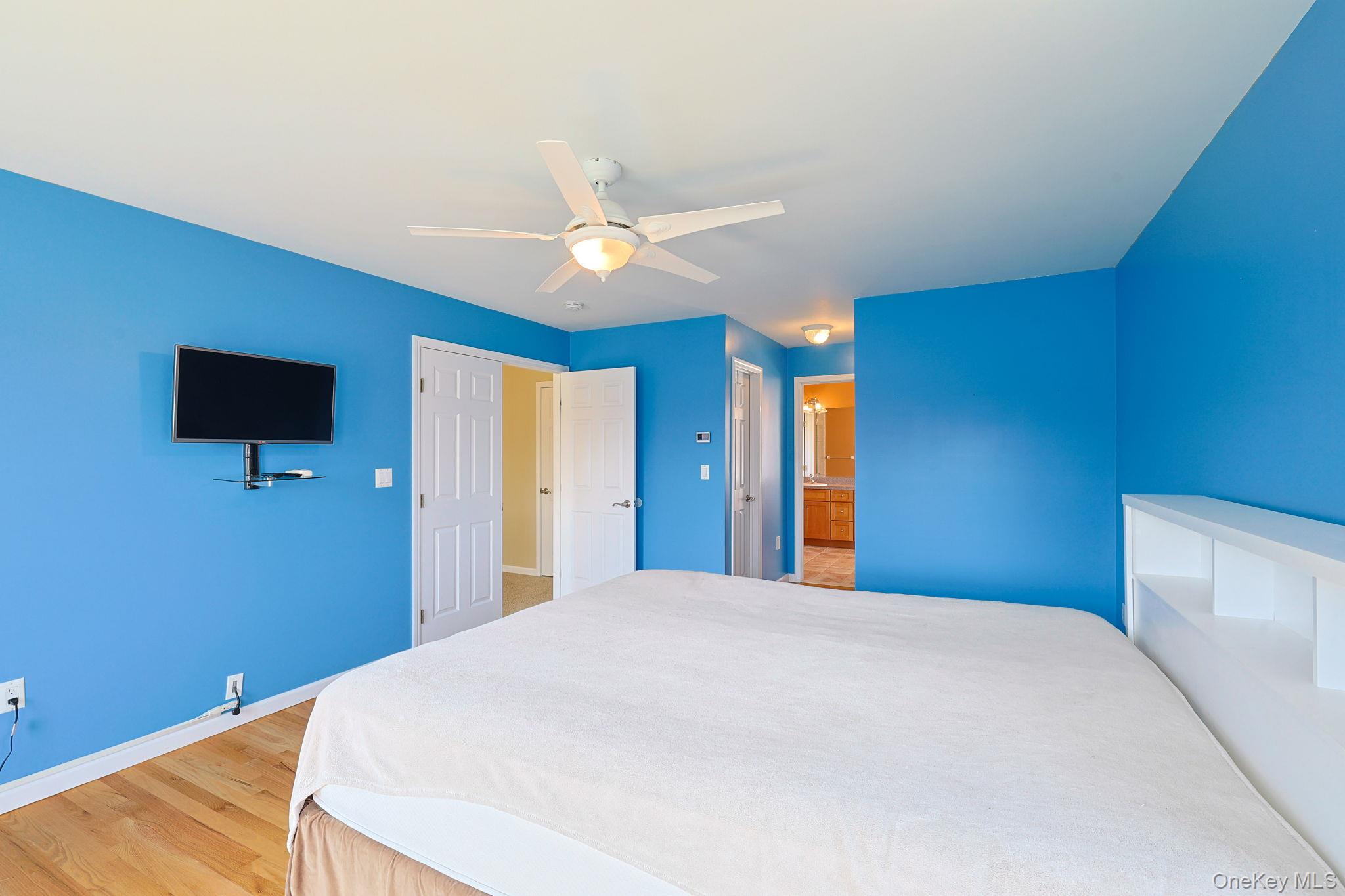 99 Country Club Road Hopewell Junction, NY 12533 - Photo 18 of 44 a bedroom with a bed and a flat screen tv