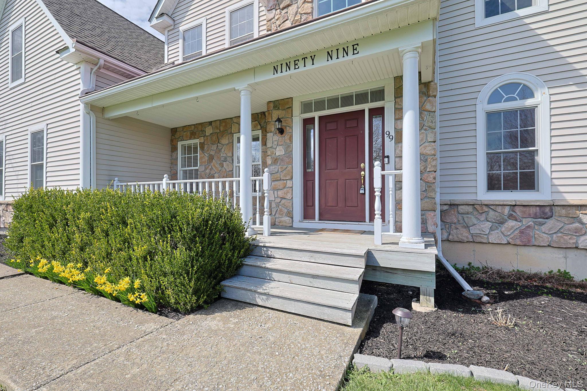 99 Country Club Road Hopewell Junction, NY 12533 - Photo 2 of 44 a front view of a house with a garden