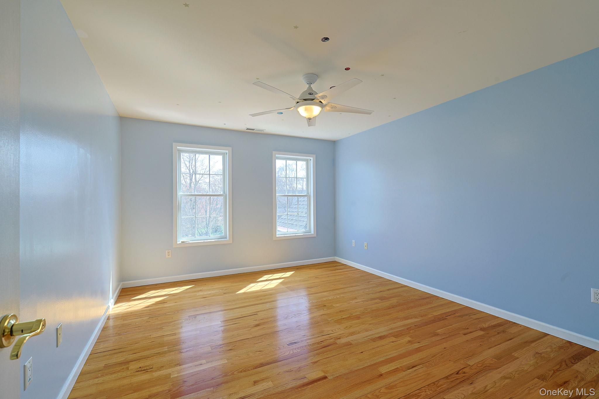 99 Country Club Road Hopewell Junction, NY 12533 - Photo 21 of 44 an empty room with wooden floor and windows