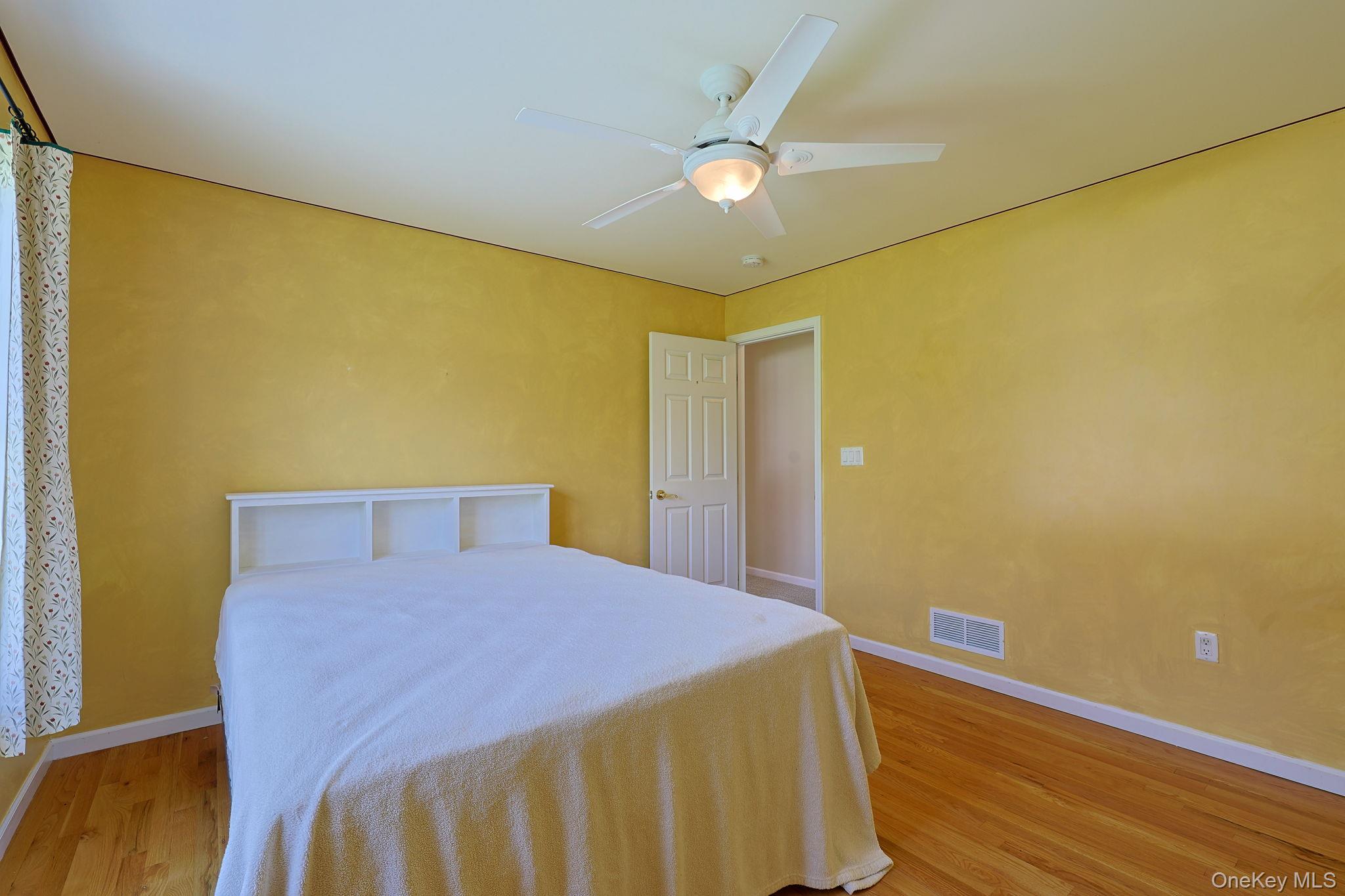 99 Country Club Road Hopewell Junction, NY 12533 - Photo 25 of 44 a bedroom with a bed and wooden floor