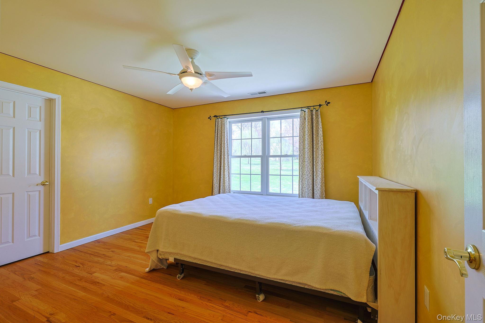 99 Country Club Road Hopewell Junction, NY 12533 - Photo 26 of 44 a bedroom with a bed and wooden floor