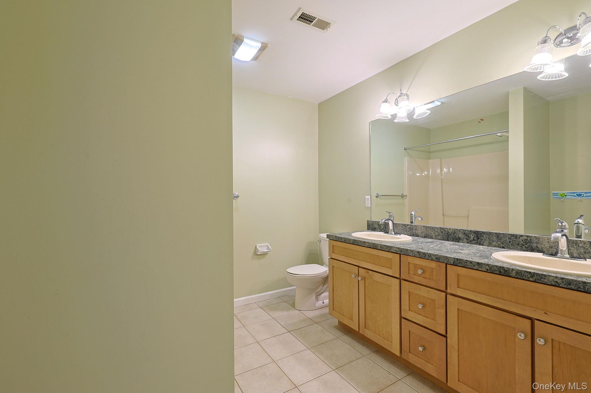 99 Country Club Road Hopewell Junction, NY 12533 - Photo 29 of 44 a spacious bathroom with a granite countertop sink a toilet and a mirror