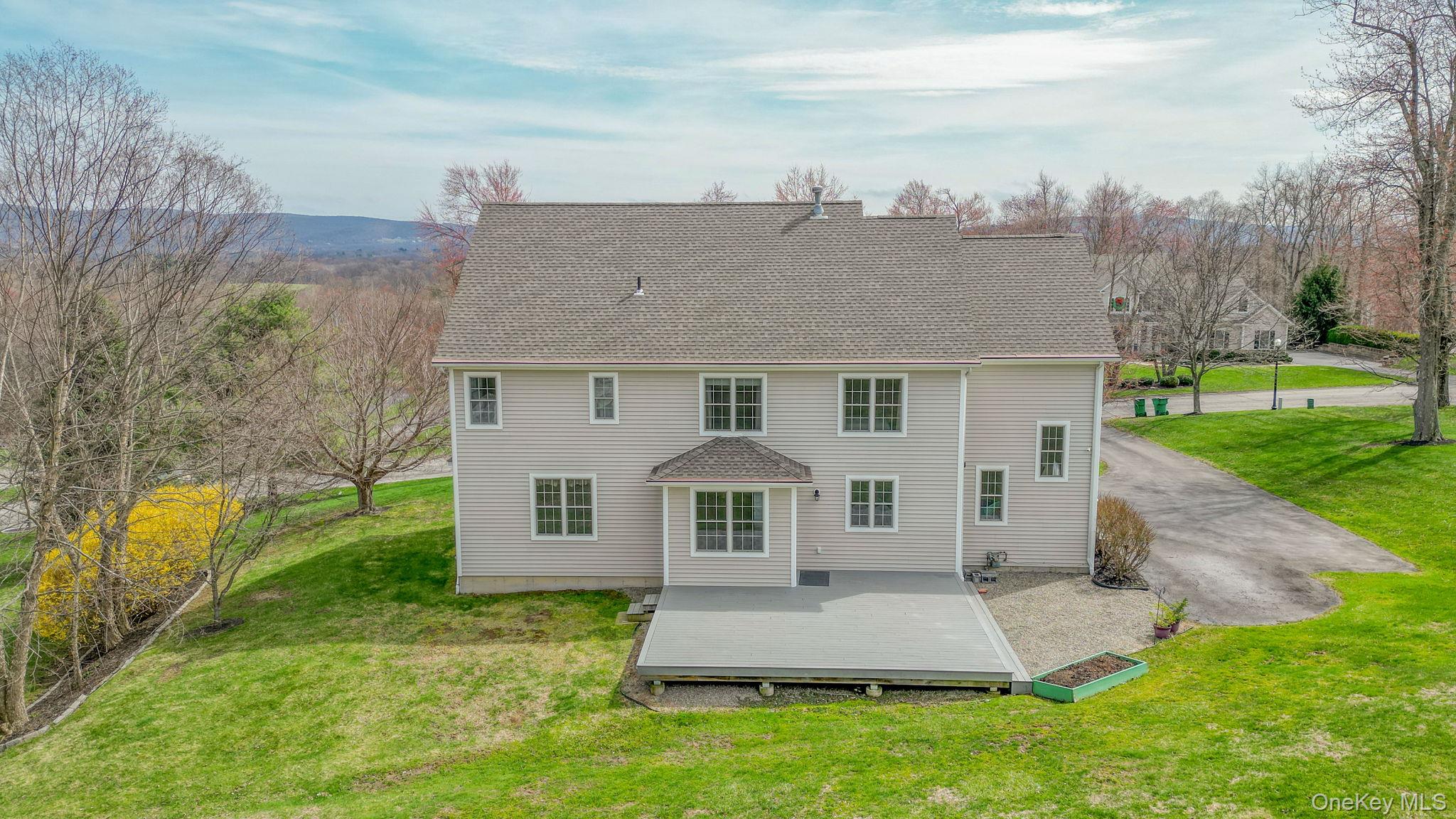 99 Country Club Road Hopewell Junction, NY 12533 - Photo 38 of 44 a front view of a house with a yard and garage