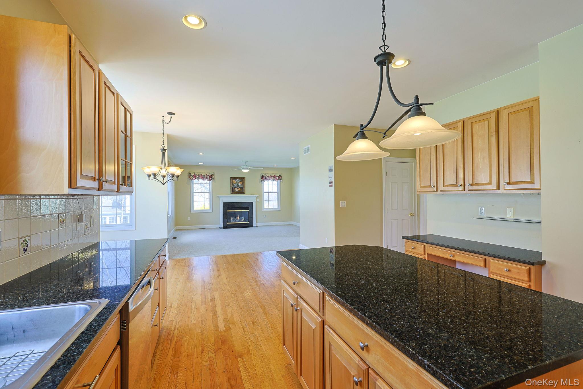 99 Country Club Road Hopewell Junction, NY 12533 - Photo 8 of 44 a kitchen with stainless steel appliances granite countertop a sink a stove and a wooden floors