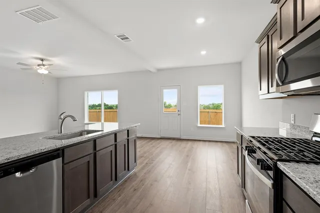 a kitchen with a sink stove and microwave