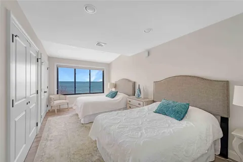 a bed sitting in a bedroom next to a window