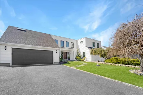 a large kitchen with granite countertop a stove a sink dishwasher a refrigerator with wooden floor