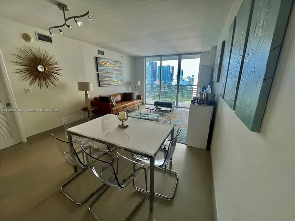 a view of a dining room with furniture and window