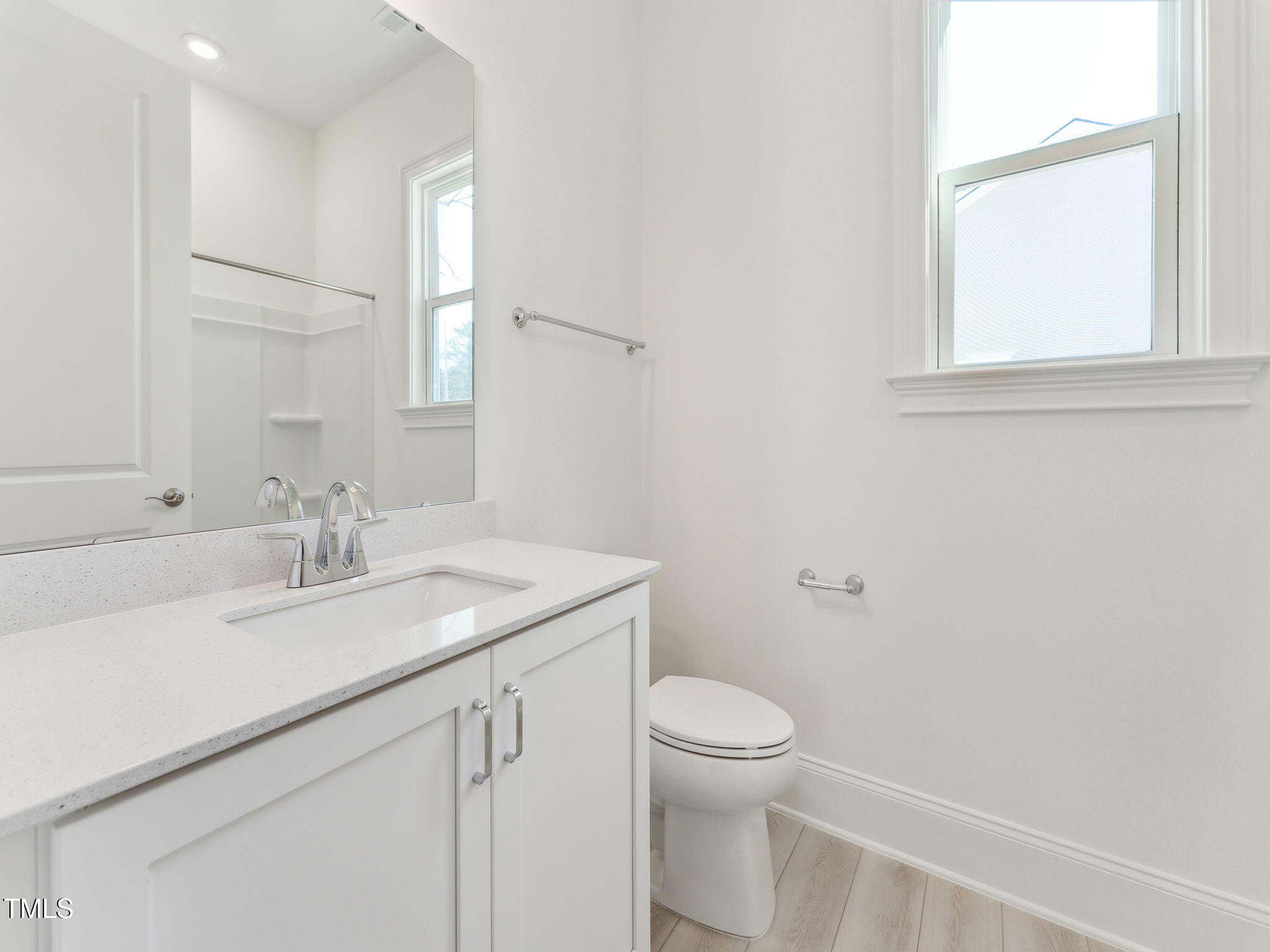 512 Gainer Drive, Unit 4 Raleigh, NC 27610 - Photo 11 of 12 a bathroom with a granite countertop sink a toilet and a mirror