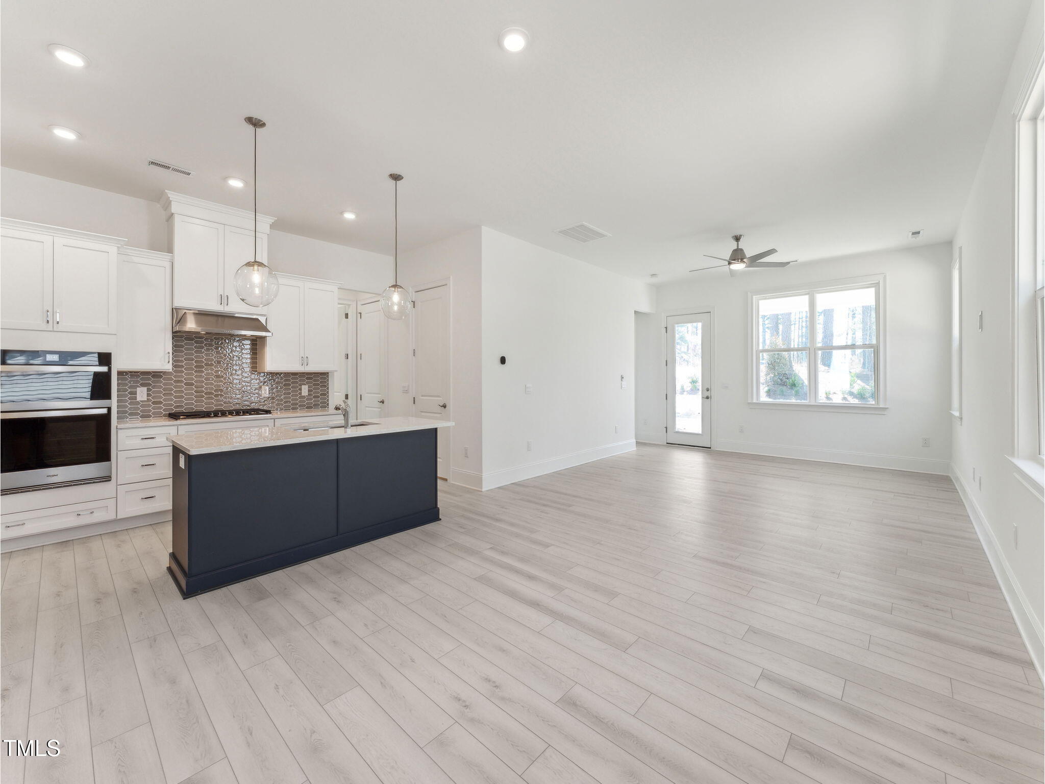 512 Gainer Drive, Unit 4 Raleigh, NC 27610 - Photo 4 of 12 a large kitchen with stainless steel appliances granite countertop a large counter top a stove and a wooden floors