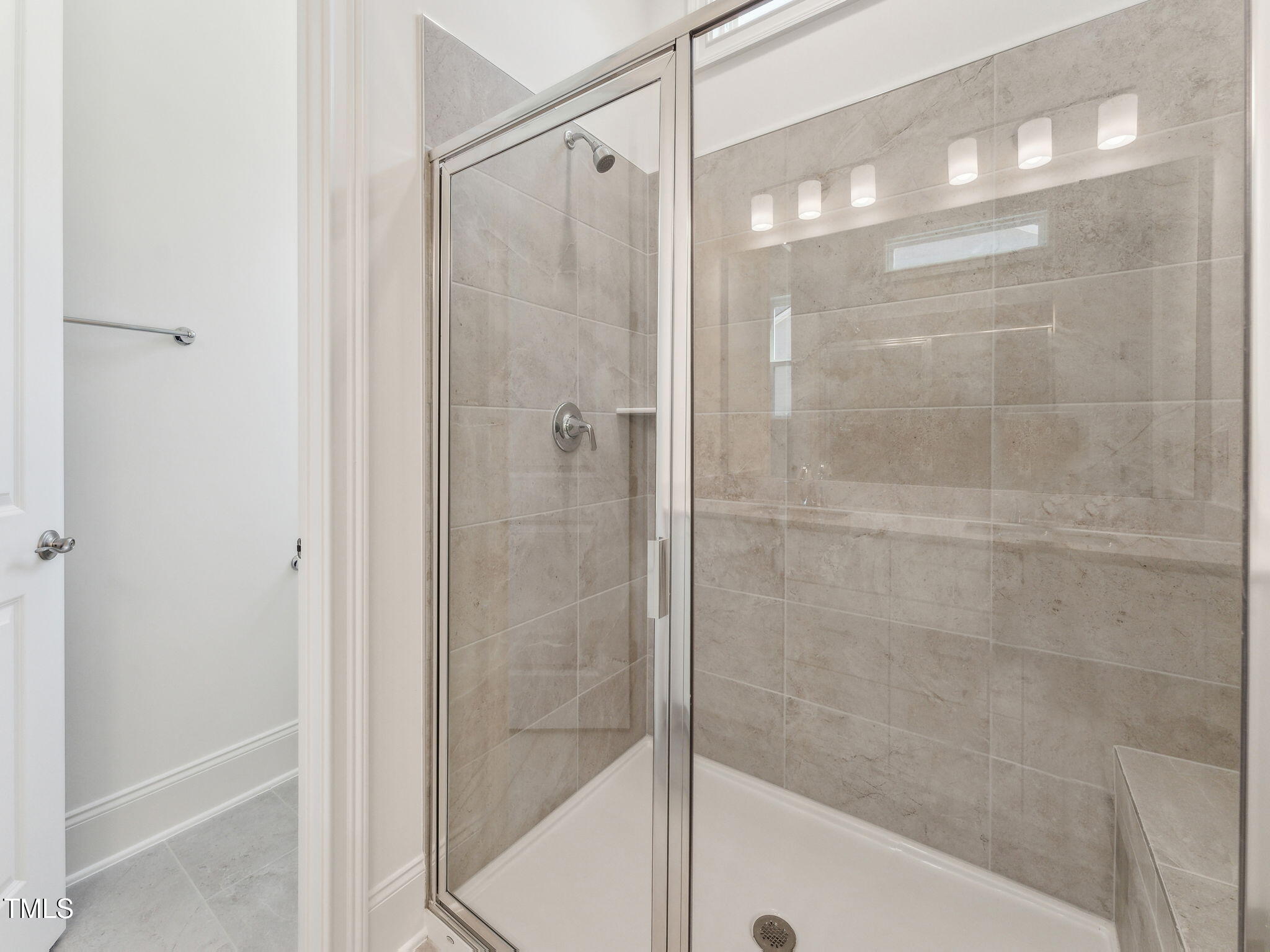 512 Gainer Drive, Unit 4 Raleigh, NC 27610 - Photo 8 of 12 a bathroom with a glass shower door