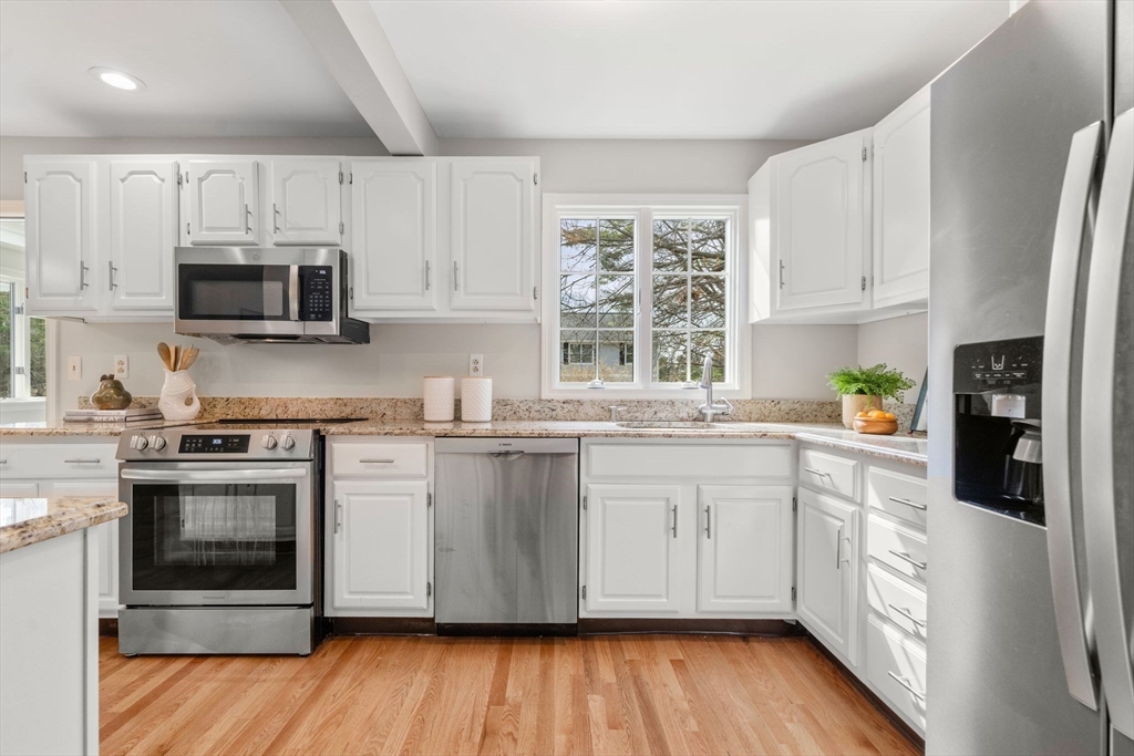 3 Eagle Drive North Reading, MA 01864 - Photo 13 of 42 a kitchen with stainless steel appliances granite countertop a stove a sink and a microwave