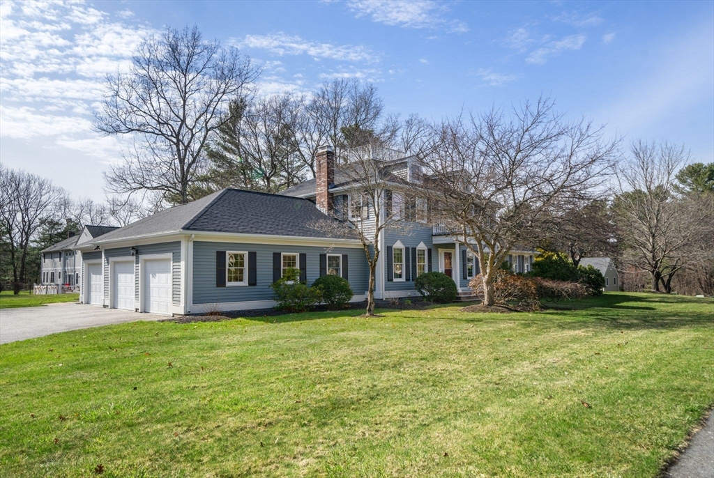 3 Eagle Drive North Reading, MA 01864 - Photo 2 of 42 a front view of a house with a garden and trees
