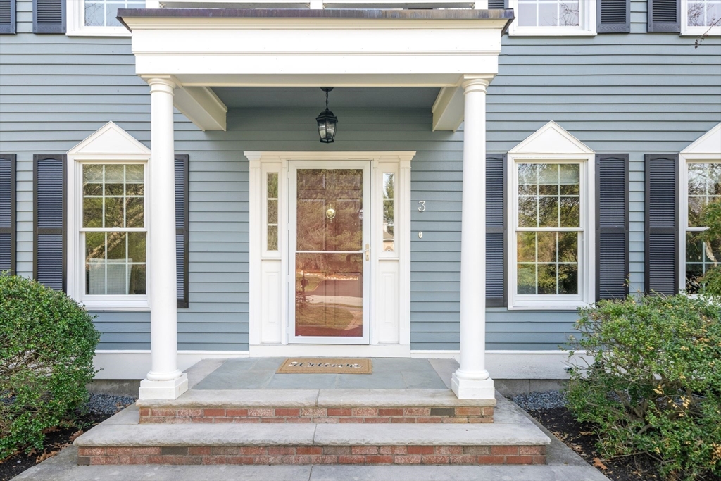 3 Eagle Drive North Reading, MA 01864 - Photo 3 of 42 a front view of a house with a yard and garage