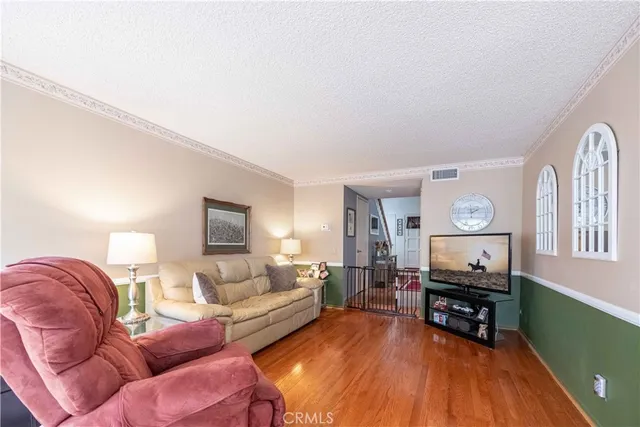 a dining room with furniture and a potted plant