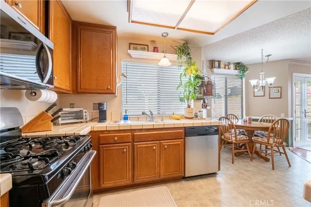 a spacious bathroom with a granite countertop sink toilet a mirror and shower