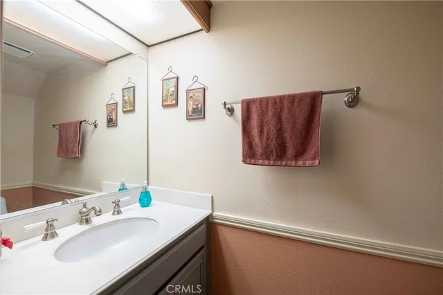 a bathroom with a double vanity sink and a large mirror