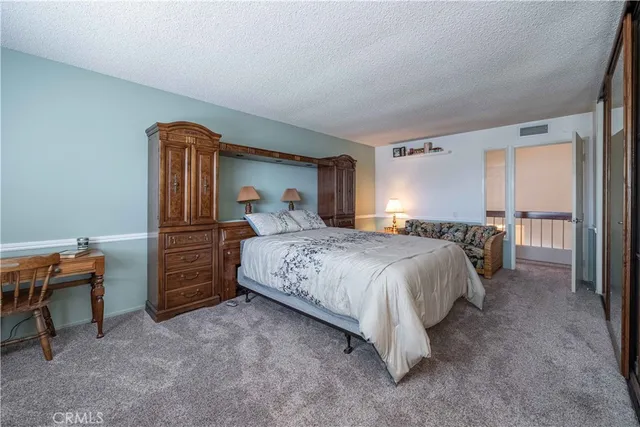 a view of a hallway with a white walls and stairs