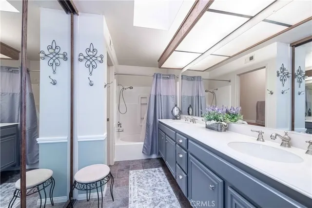 a bathroom with a sink vanity and a mirror