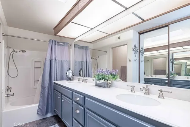 a view of a patio with a table and chairs under an umbrella with a barbeque