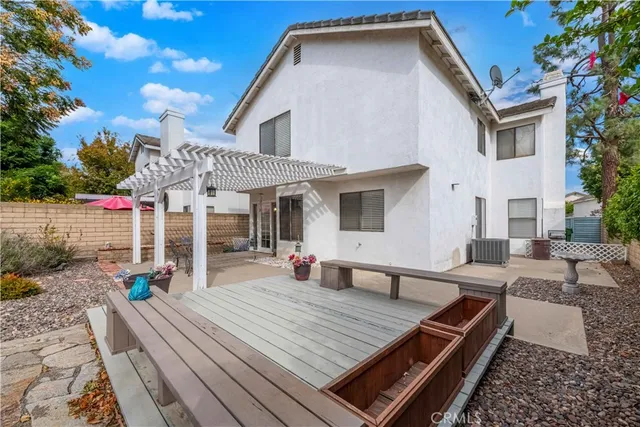 a view of a house with backyard and chairs