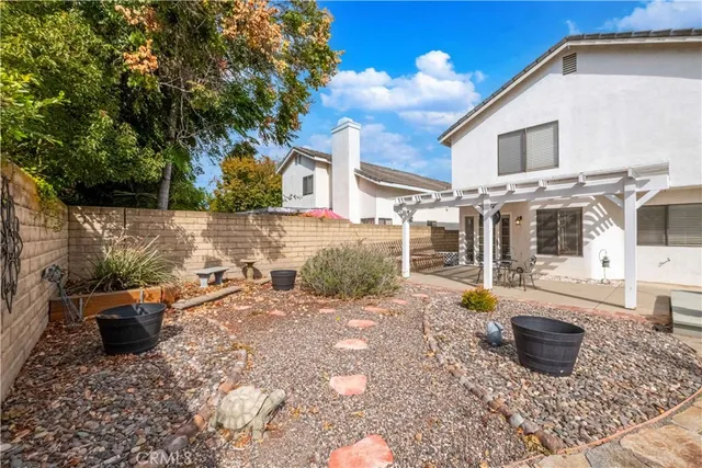 a view of a swimming pool with a chairs in patio