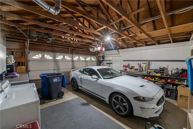 an aerial view of a city with lots of residential buildings and mountain view in back