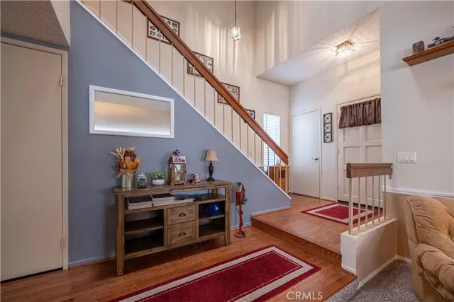 a living room with furniture a rug and a lamp