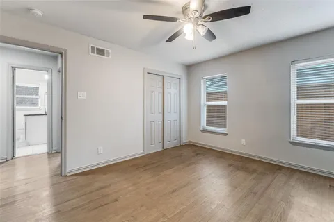 a bathroom with a granite countertop toilet sink and mirror