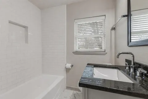 a bedroom with a bed and a ceiling fan