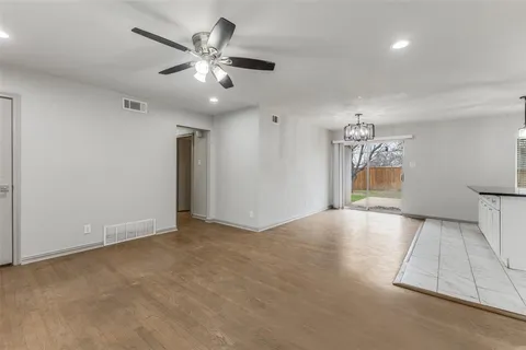 a kitchen with stainless steel appliances granite countertop a stove cabinets and wooden floor