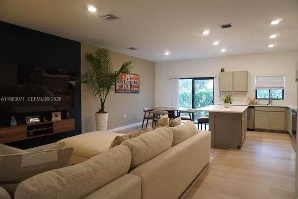 a living room with furniture and a flat screen tv