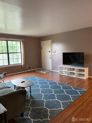 a room with furniture pool table and a large window