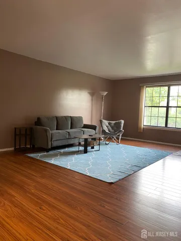 a view of a livingroom with furniture nad wooden floor