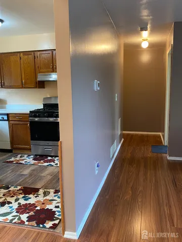 a view of a kitchen with wooden floor