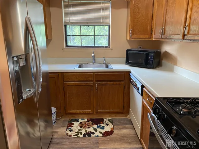 a kitchen with a sink stove and refrigerator