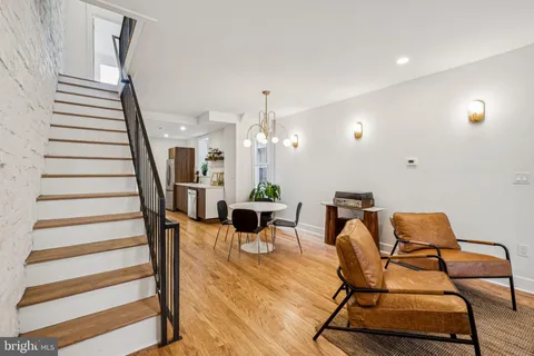 a view of a hallway with wooden floor and entryway