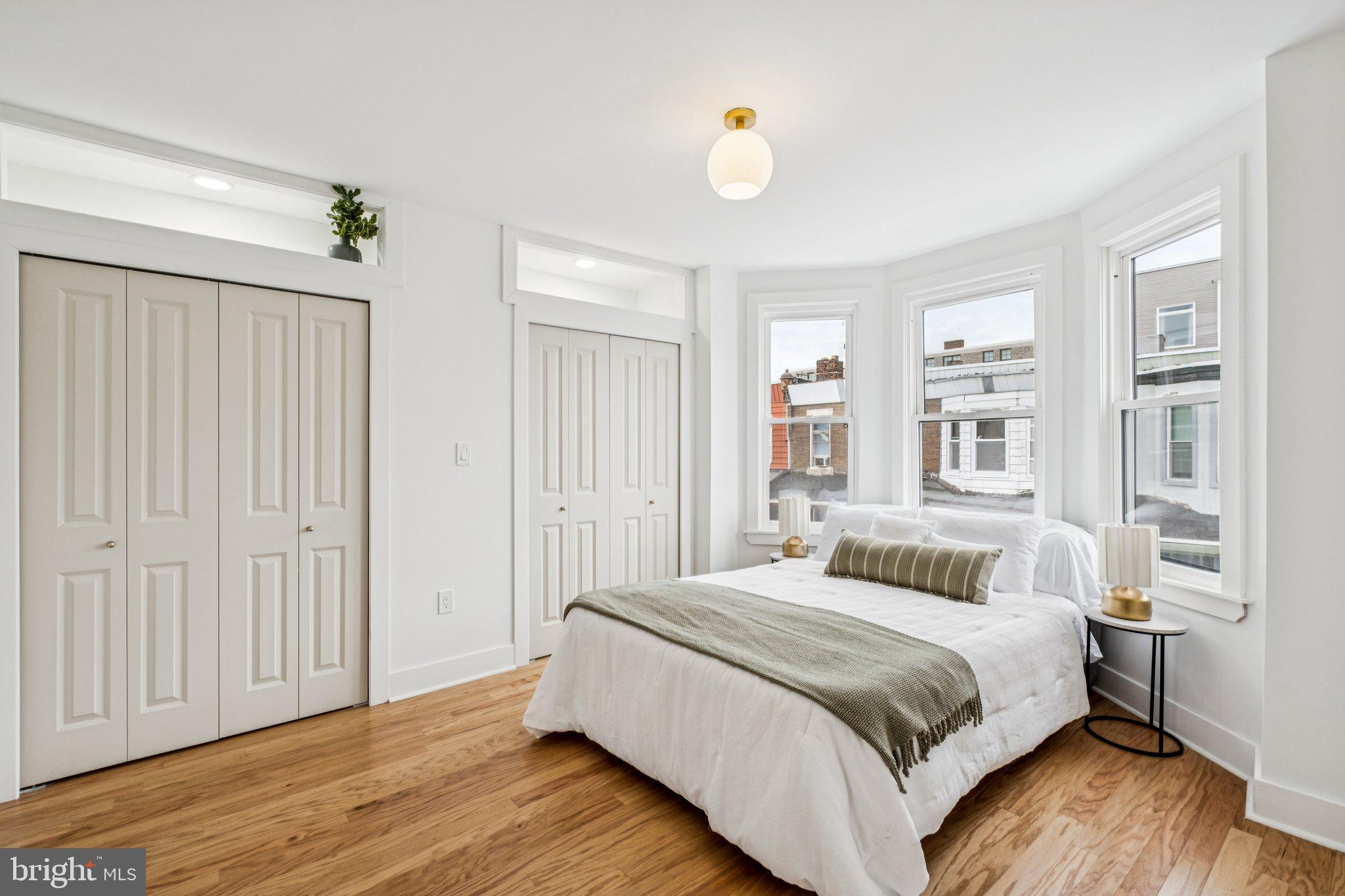 3010 Redner Street Philadelphia, PA 19121 - Photo 14 of 27 a bedroom with a bed and wooden floor