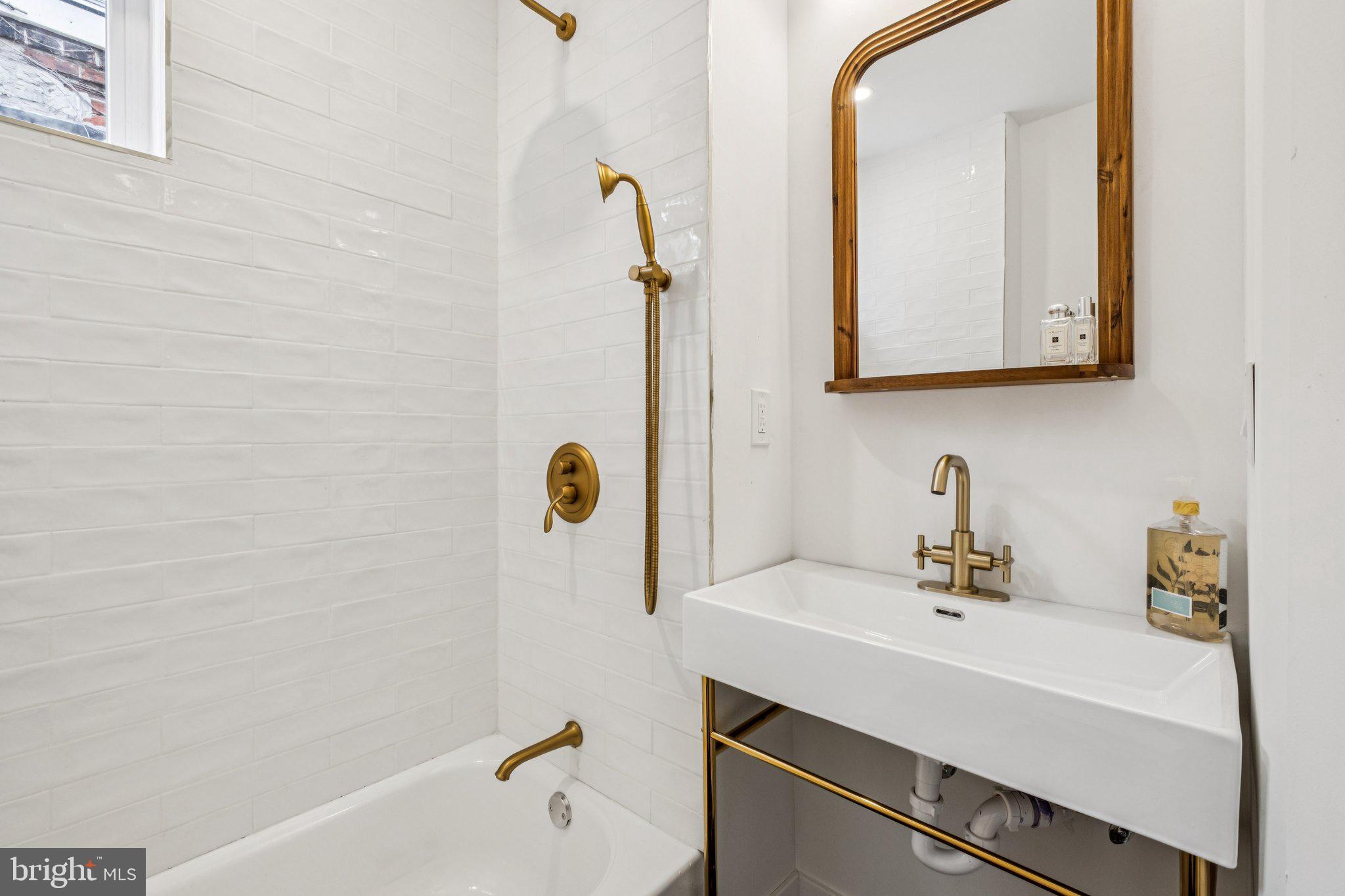 3010 Redner Street Philadelphia, PA 19121 - Photo 17 of 27 a bathroom with a sink and a mirror