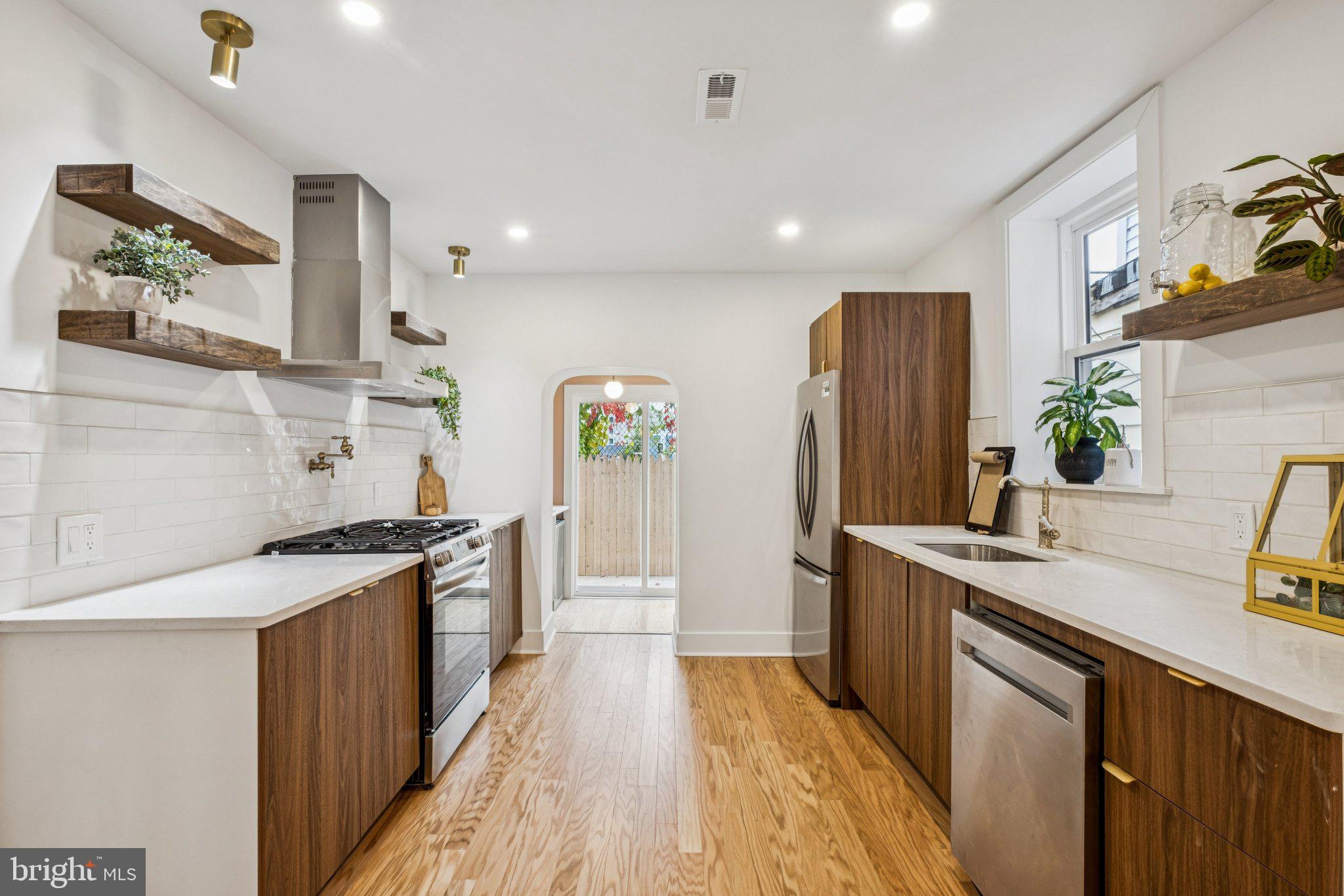 3010 Redner Street Philadelphia, PA 19121 - Photo 5 of 27 a kitchen with stainless steel appliances granite countertop a sink stove and refrigerator